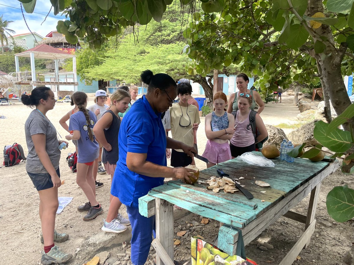 CHCNexus's tweet photo. Fresh coconuts on the beach! After a challenging hike, we enjoyed lunch together and then stepped over to the beach. One of our adventurers said drinking a coconut on the beach in the Caribbean was a bucket list item, so we couldn’t pass up this opportunity! #chcCuracao22 https://t.co/i1WWwKwG73