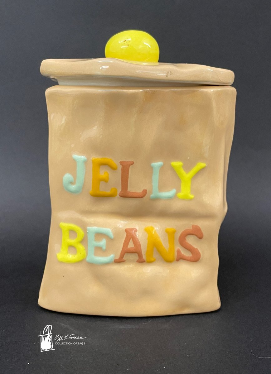 41/365: This ceramic container was designed to look like a brown paper bag. Labelled with multi-color letters, the bag reads 'Jelly Beans.' A yellow ceramic knob on the lid takes the shape of a jelly bean to finish off the design. The container is signed by H. Shfug.