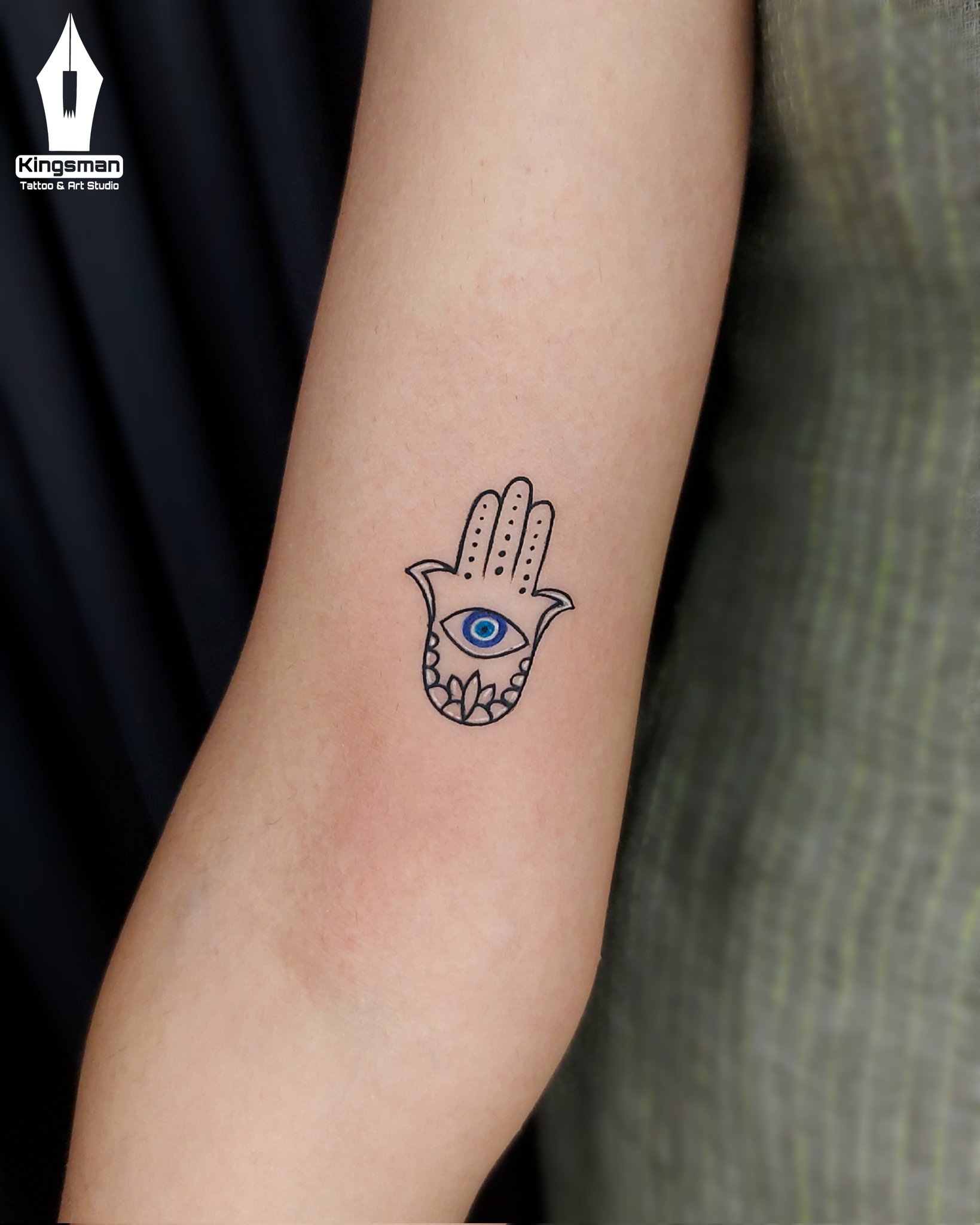 Minimalistic style evil eye tattoo done on the wrist