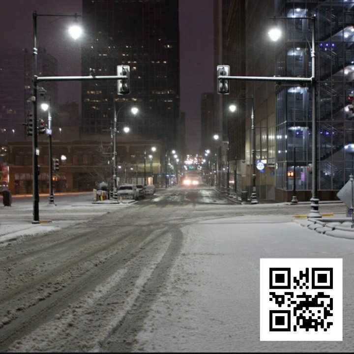 Photo of snowy city street with inset of a QR Code for parking during snow storm.