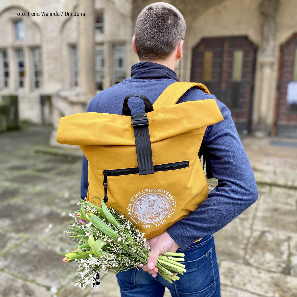 One person presents flowers to our university.