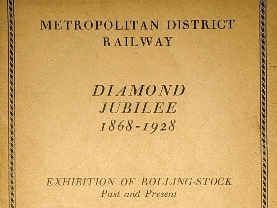 The front of a beige pamphlet that says “Metropolitan District Railway Diamond Jubilee (1868-1928) Exhibition of Rolling-Stock Past and Present”.