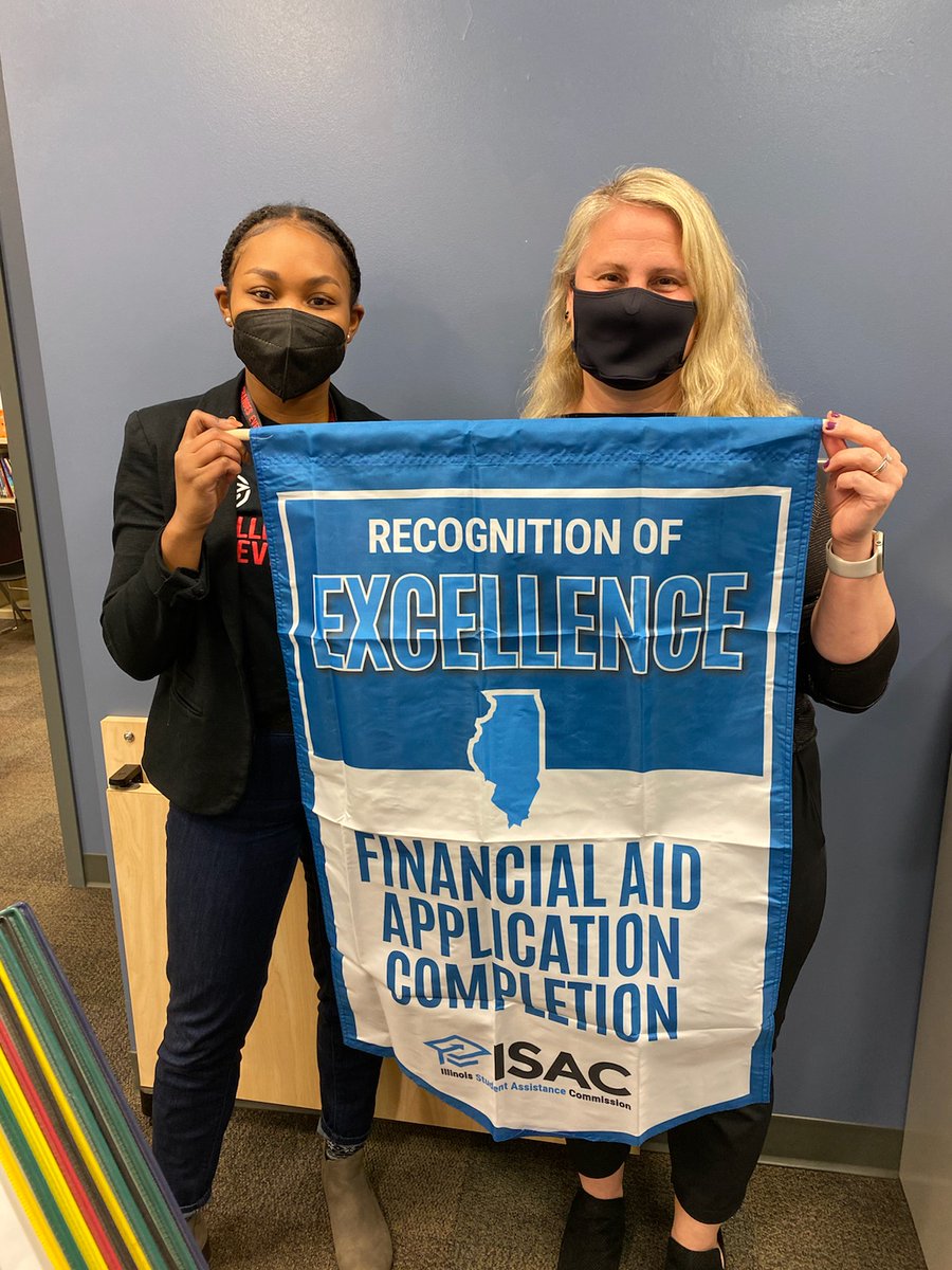Johnsburg High School was presented a banner for achieving Bronze Honors for an exemplary rate of financial aid applications by the class of 2021!! 
Here is Mrs. Ault, JHS School Counselor with an Illinois Student Assistance Commission (ISAC) rep displaying the banner.