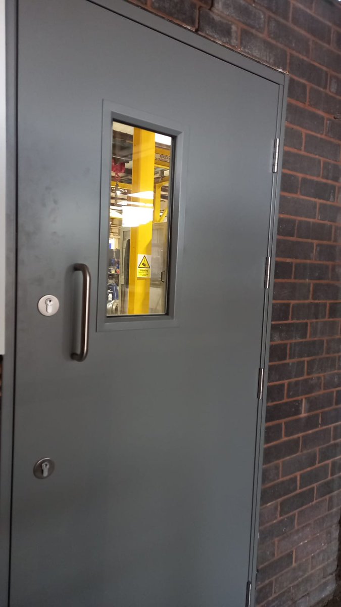New security doors installed to replace weathered wooden doors.