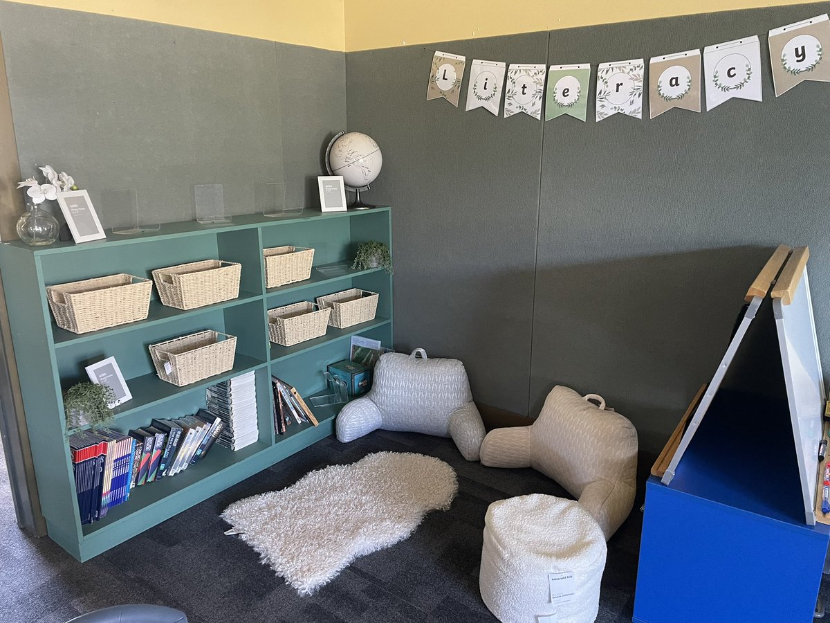 missbdeakin's tweet photo. Getting there… covered the cushions, added some new cosy bits &amp; brightened with baskets/plants… and of course some books! Just waiting on the book review display work next but a much more inviting space 🤍📚 https://t.co/EiYj4xQR3g