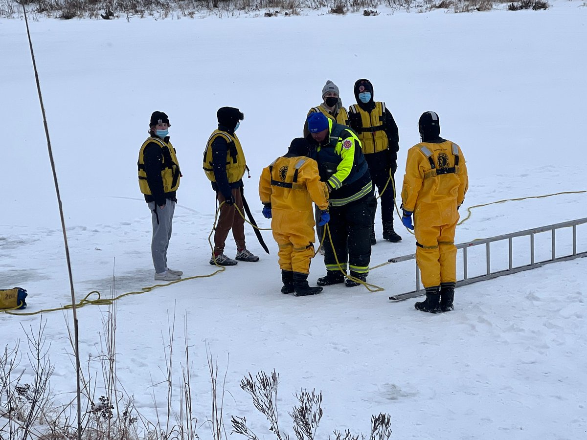 District128's tweet photo. #D128DARING VHHS Outdoor Adventure Ed Ss and teacher Jesse Wolter are collaborating with members of the Countryside Fire Protection District for the annual ice water rescue lesson at the pond near the school today. Read more in tomorrow's edition of ePawPrints. https://t.co/l8uXeM3xN1