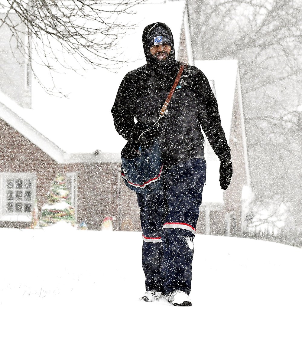 Mail carrier Cobe Clay trudges through the snow as he goes about his appointed duties delivering the mail in the 1200 block of East 7th Street in Anderson Thursday during the snowstorm.