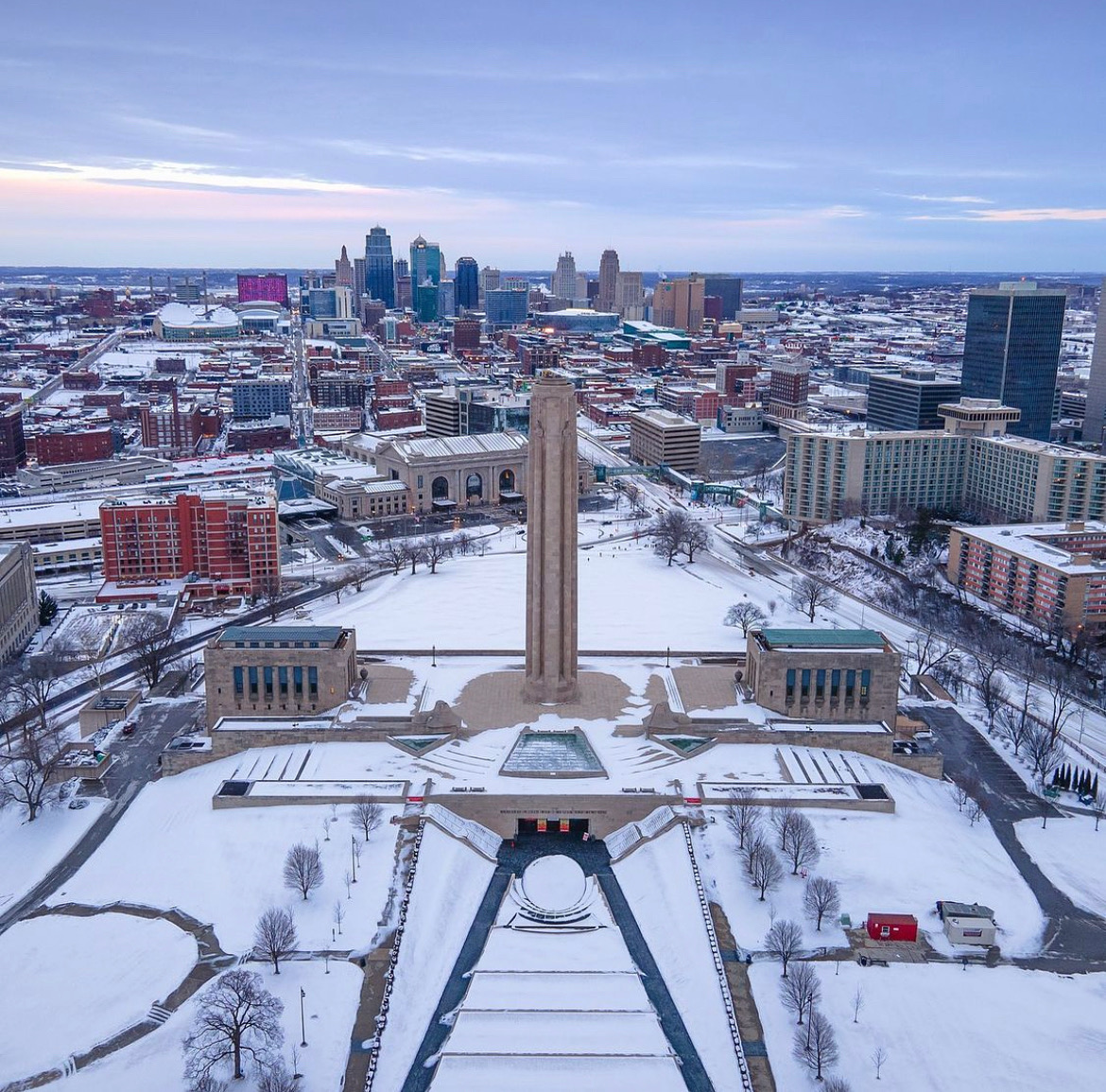 TheWWImuseum's tweet photo. It’s rare to see aerial views of the Museum and Memorial under a carpet of snow! Great photograph of our grounds with the #KansasCity skyline by local photographer Scott Blair.❄️ https://t.co/Cqer5lJgPr