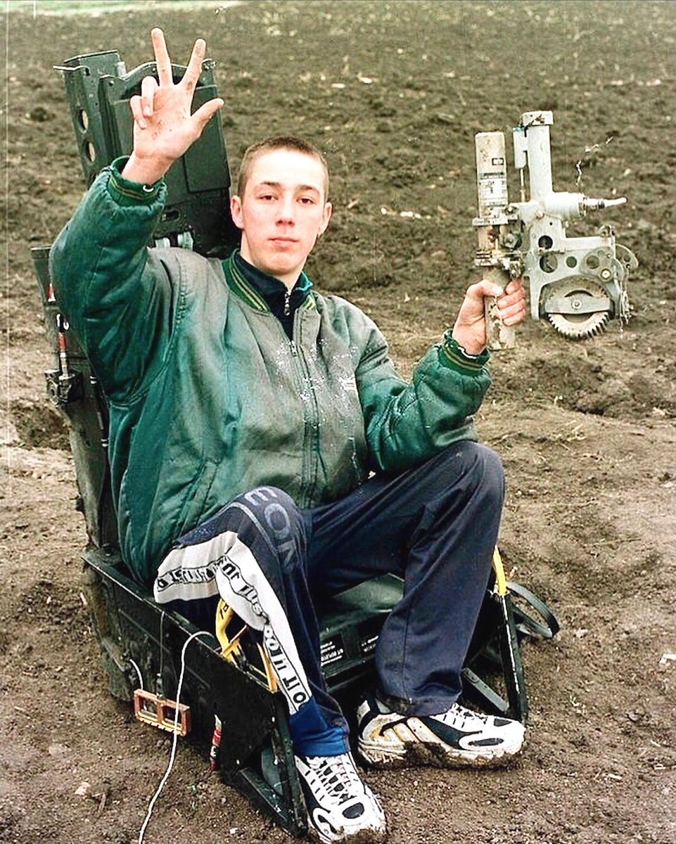 A Serbian boy pose in the ejection seat of an F-117 Nighthawk, after it was shot down during the NATO bombing of Serbia in 1999.