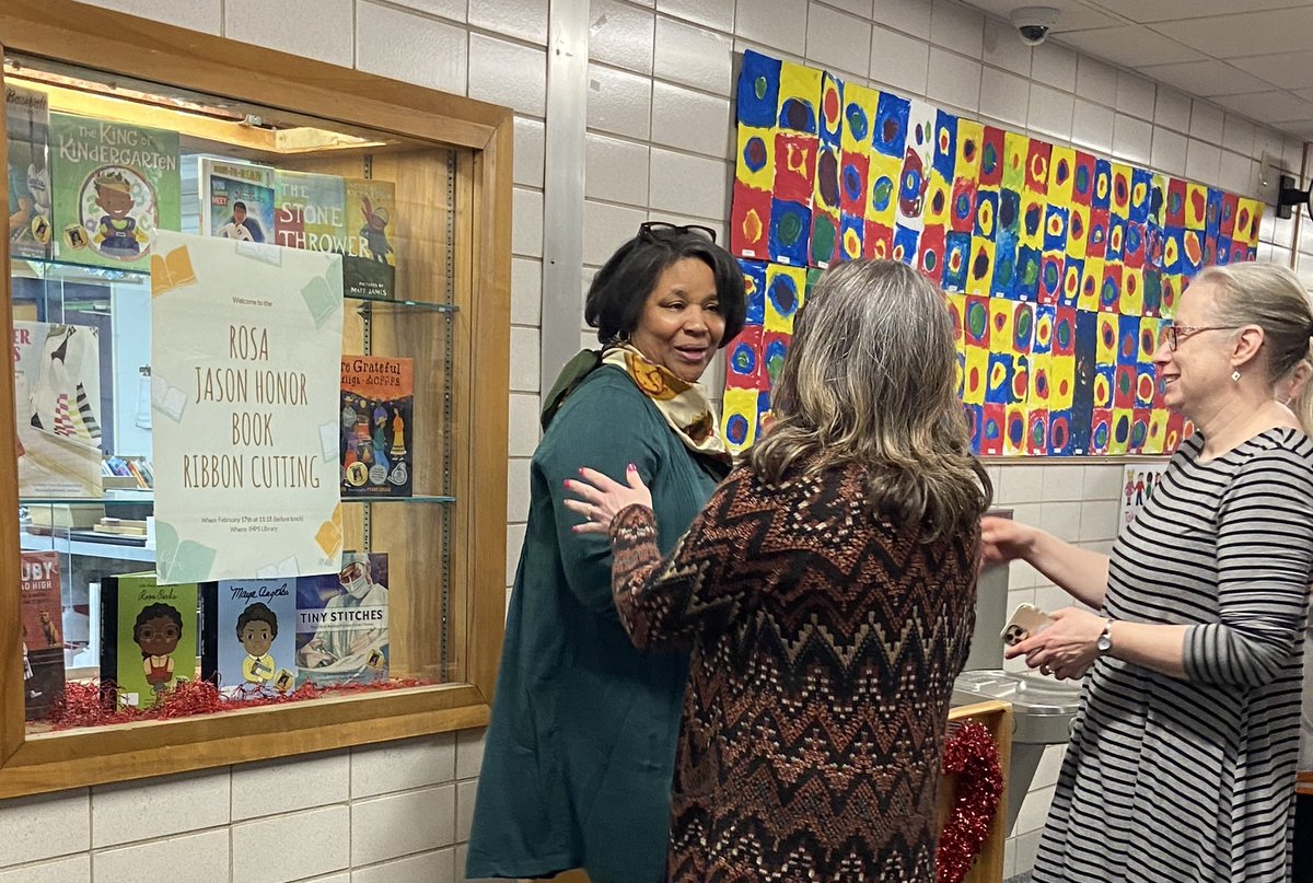 IHPSSpanish's tweet photo. We loved celebrating the culmination of a years-long passion project of our lovely former colleague, Rosa Jason. We officially cut the ribbon on the “Rosa Jason Honor Book” collection at the PS library. Special thanks to @ihpto and @JenAndersIHPS! #ihpromise #epicihps ❤️🖤 https://t.co/vI5CWXuvKB