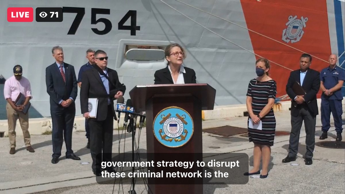 Deputy Assistant Attorney General Jennifer Hodge of the Justice Department's Criminal Division delivers remarks behind podium in front of USCG Cutter James at offload of approximately $1.06 billion in cocaine and marijuana at Port Everglades, Florida.