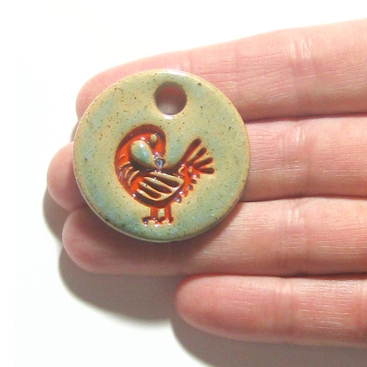 JKCJewelry's tweet photo. Orange Sankofa Large Artisan Pendant Necklace, Adinkra Necklace, African Symbol, Ceramic Pendant, Stoneware, Akan Tribe Symbol https://t.co/rsGGvK2lle #ceramics #art #handmade #pottery #CeramicBead https://t.co/8GtvIYishp