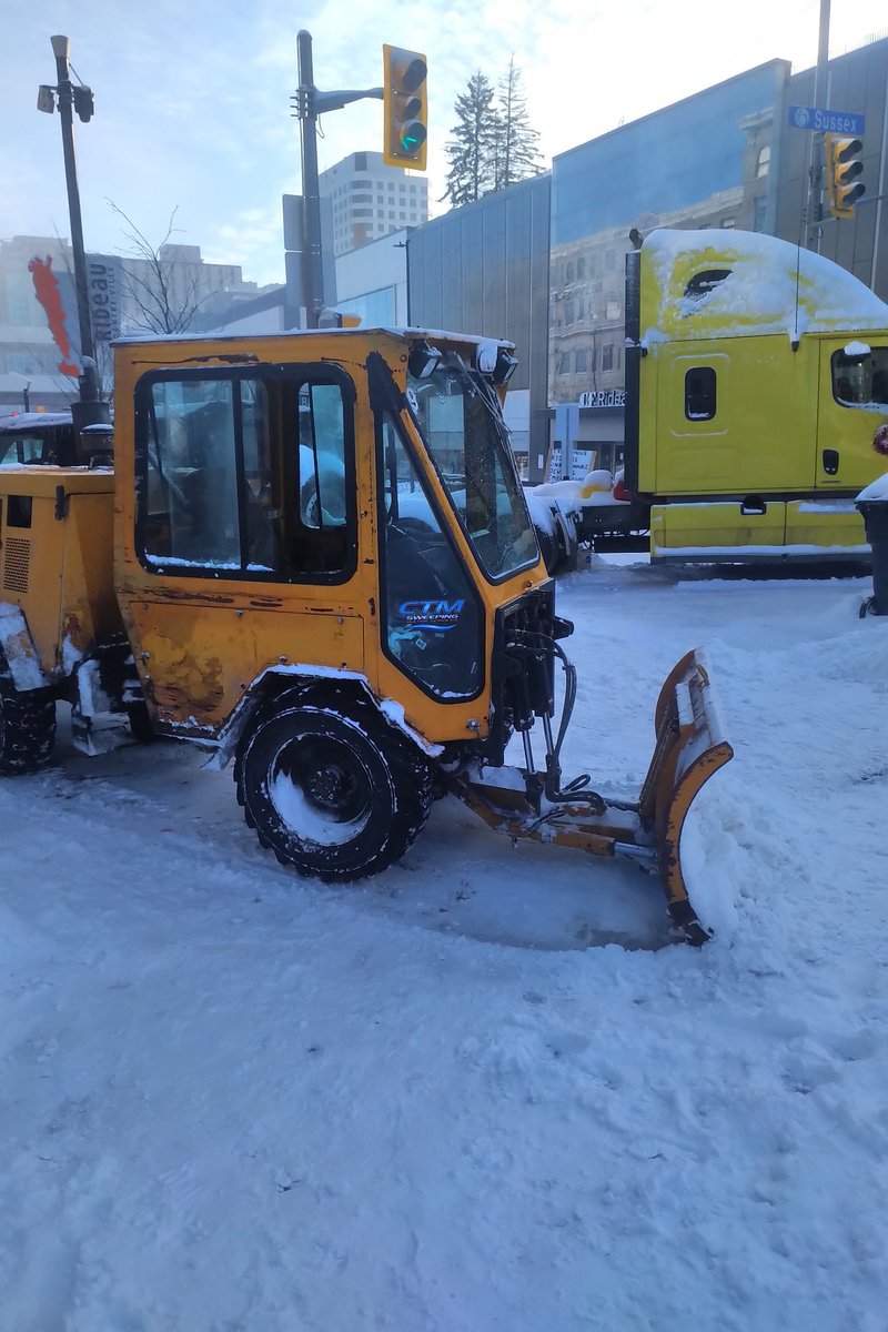 Justin_Ling's tweet photo. Call went on the scanner recently that a snowplow had been carjacked. Looks like the occupiers are using it to reinforce the line. (It's empty and idling.) https://t.co/gGKH26wDKn