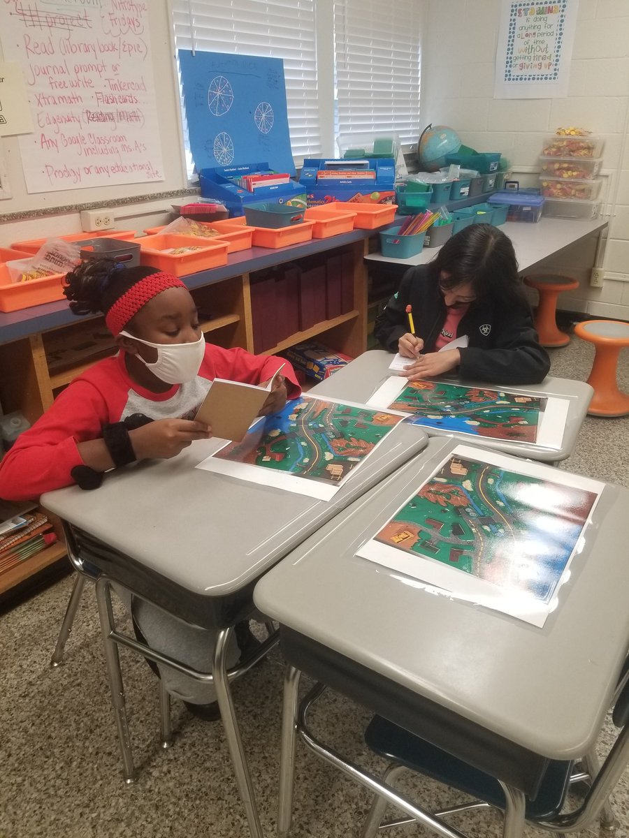 Students are discussing what they notice, think, and wonder about the enviroscape!