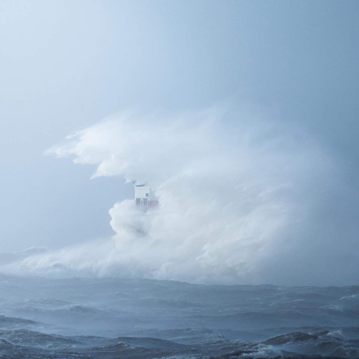 sky_n_sand's tweet photo. #StormEunice at IJmuiden during the peak with 140km/h wind. Can you spot the lighthouse? 🤣Love the raw power of nature! Well.. until my garden fence flew away at my home.. https://t.co/d26iwW3qSr