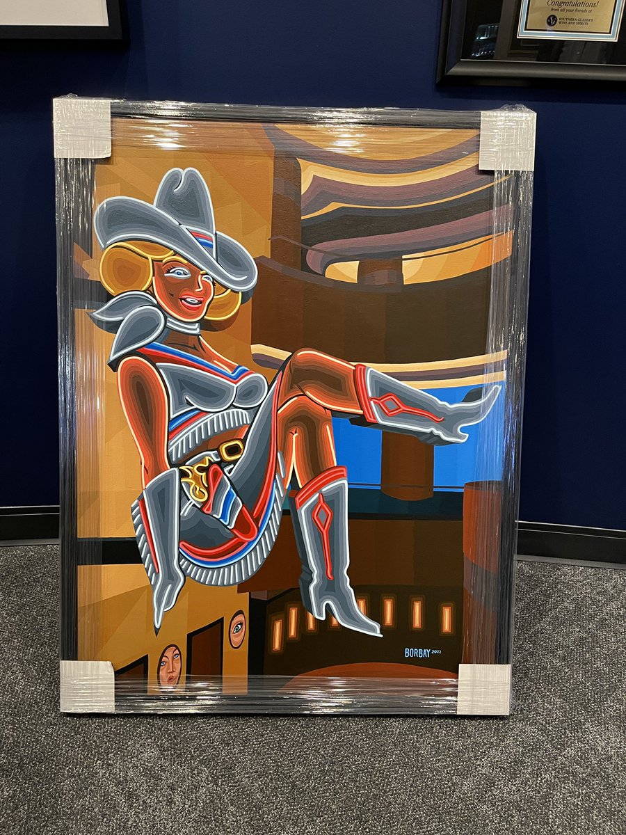 CircaLasVegas's tweet photo. The neon is bursting through the frame. 🤩

@borbay’s magnificent @VegasVickie painting has been framed and tucked away in a secure location…until its next move. 👀 https://t.co/R756iKLuZp