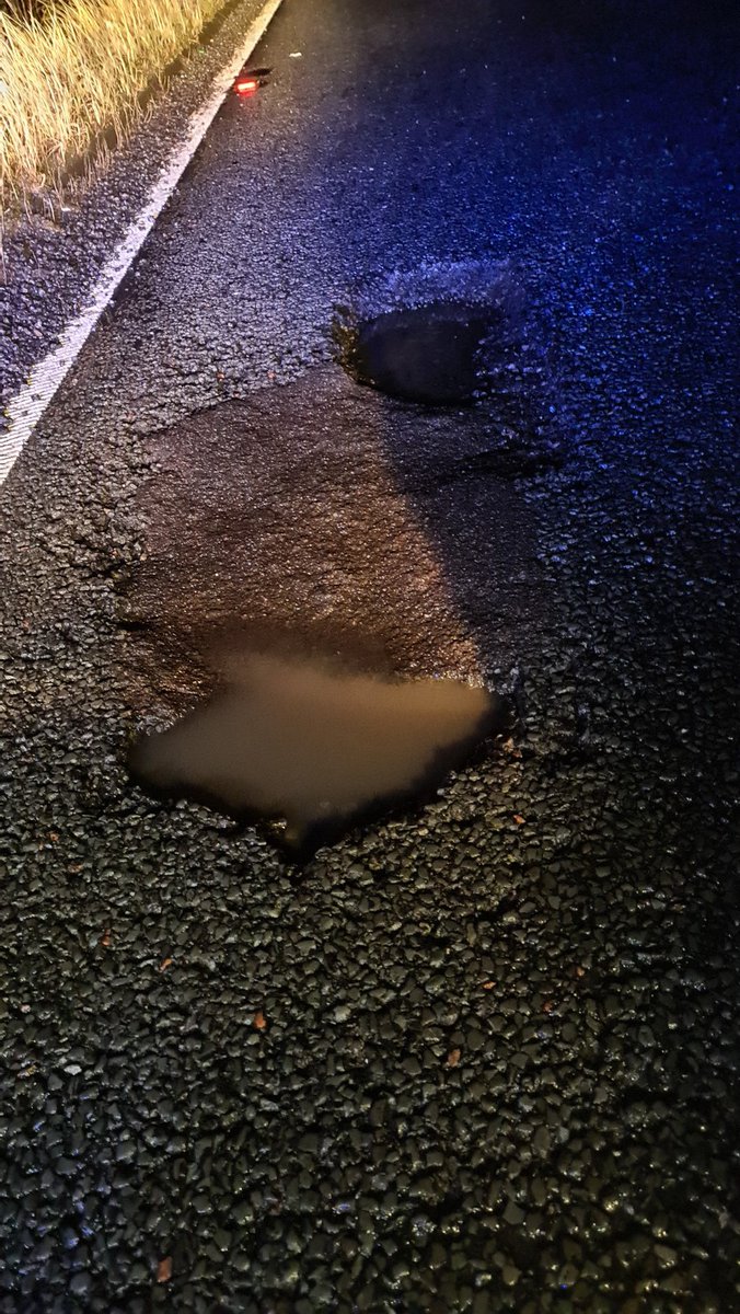 sc7138's tweet photo. These two pot holes resulted in 30 cars being damaged on the #A616 last night. Myself and 7049 prevented any further damage whilst waiting for Highways England to attend and repair. #StormEunice https://t.co/R49JmzmAzr