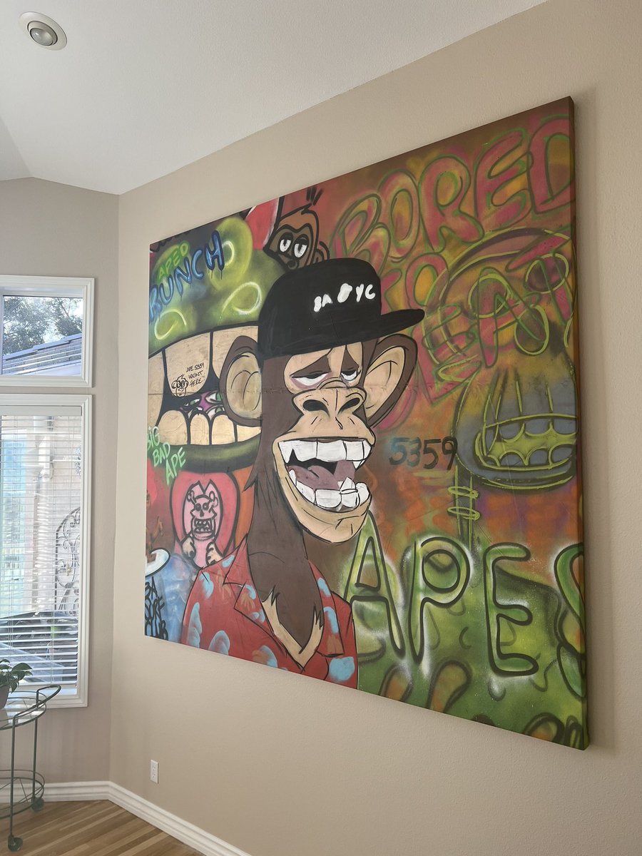 Finally got my <a href="/BoredApeYC/">Bored Ape Yacht Club 🍌</a> painting from ApeFest’21 <a href="/brtmoments/">Bright Moments</a> stretched and on the wall. Art by <a href="/yonmeister_art/">yonmeister</a> <a href="/rube_zilla/">rube.zilla</a> <a href="/APEDcollective/">APED</a> Glad my wife loves #BAYC and let me hang an 8ft painting in the house. #nftart #graffitiart