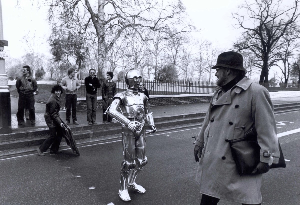 RoyalAlbertHall's tweet photo. 🎈 Happy 90th Birthday John Williams 🎬

We love sharing your music, especially as part of our #FilmsInConcert series, which has included Star Wars, Harry Potter, Jurassic Park, Jaws &amp; E.T... to name a few 🤯

📷 John Williams &amp; C3PO crossing the road outside the Hall, 1978 https://t.co/cSNB0oPWqP