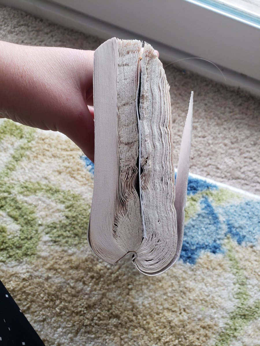 mothsloth's tweet photo. @DanielBGreene I'm gonna give you this here because I always miss these calls for pics. Behold, the most ironically fucked up but still technically readable book. Turns out bad salt lamps can leak salt into the air and this pirate history book was right by it so it looks like a sea barnacle. https://t.co/YKaAupjqdE