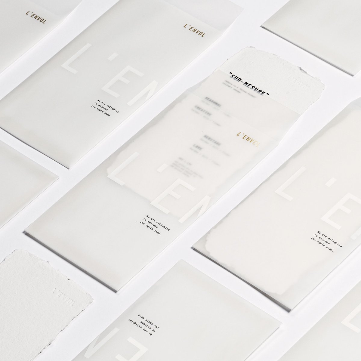 HugePaperInc's tweet photo. L’envol is Hong Kong’s venue for French cuisine—with an elegant #stationerysuite. Custom die-cut business card fold—smooth outside with #goldfoilstamp, and inside w/ a subtle visible fibre. #Deckleedge note cards for the win, and #whiteink on #translucent envelopes! https://t.co/X4qY9mVEjI