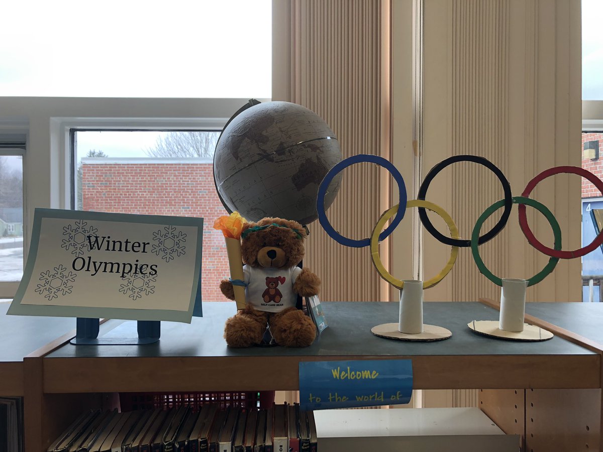 The library’s <a href="/MedfieldCares/">Medfield Cares About Prevention - MCAP</a> bear has become a torch bear-er in the center of our #Olympics book display! #BeProudBeDale