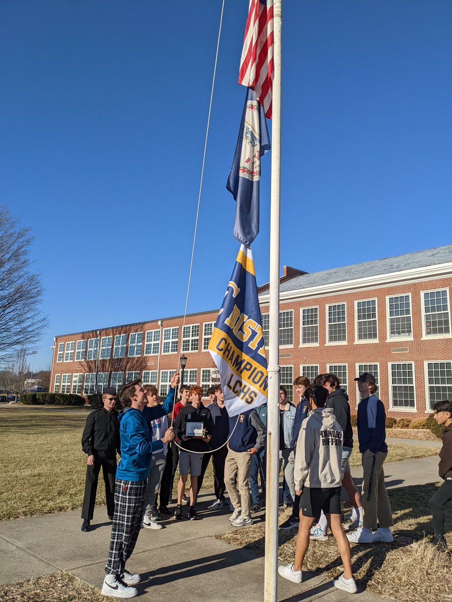 Boys Track raising the District Champion flag!