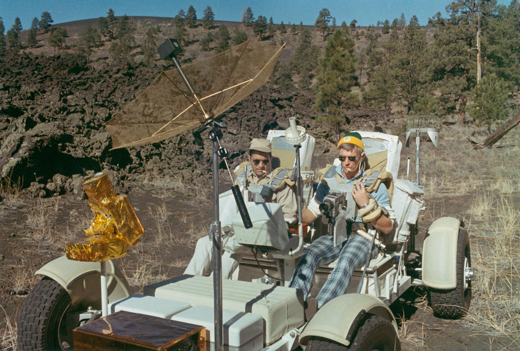 Apollo Grover Historical Photo: B9 - Eugene Cernan (right) and Harrison Schmitt drive Grover; Sunset Crater lava flows visible in background.