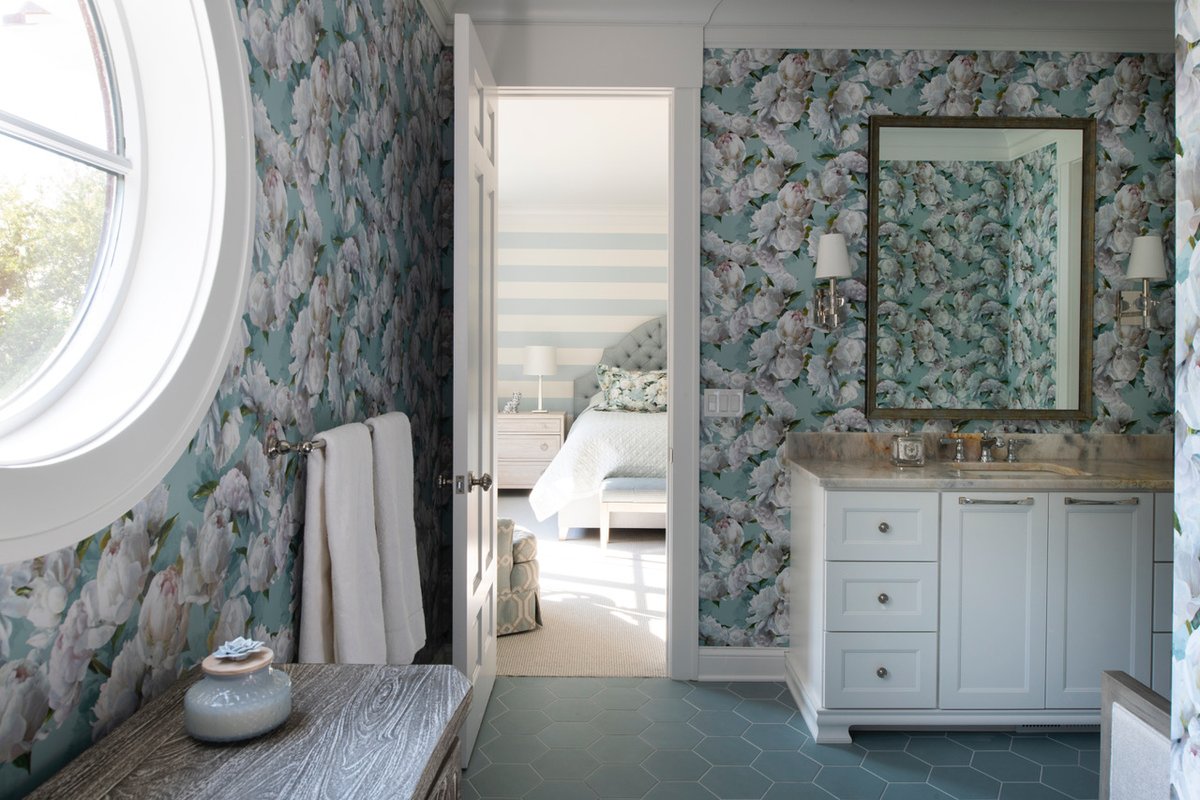 Whimsical wallpaper, soft blue hues, and unique finishes give this guest bathroom all the character.

michelshomes.com/portfolio/lake…

#bathroomdesign #wallpaperideas #cabinetrydesign