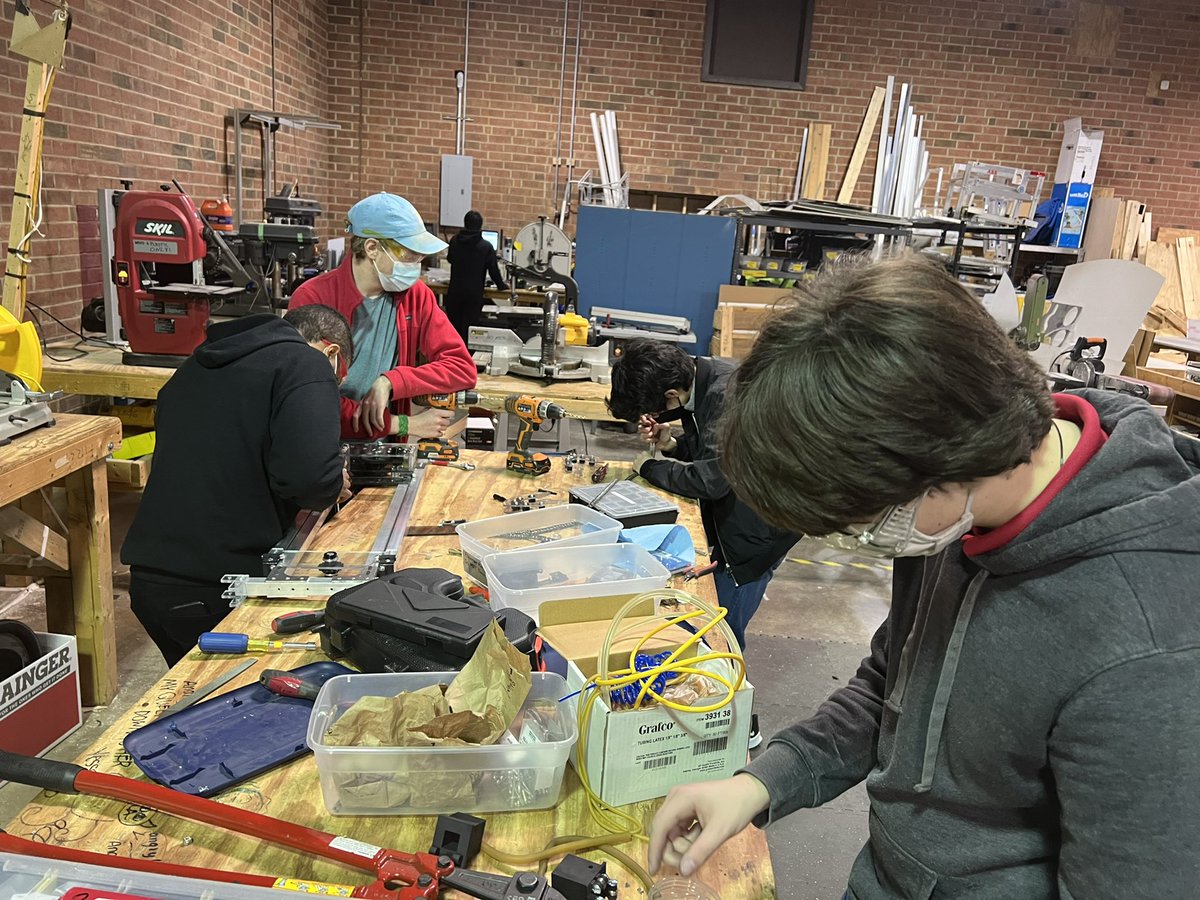 bart_carlson's tweet photo. We are looking good. Our elevator is coming together James and Conor,Devon under the watchful eyes of Mr Korey Gaddy and Ms. Ginina. Rishi on the CNC cutting out the shooter to be built on Thursday night meet. Fredrick and Apple and Nolan are programming the lime light. https://t.co/kO3G4oomE9