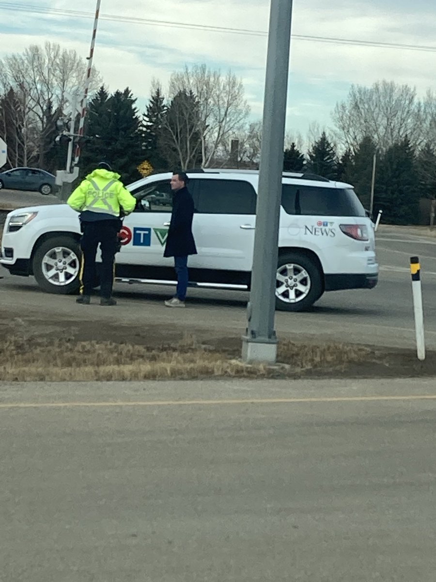 DraglineTim's tweet photo. Just leaving the police blockade south of Milk River, &amp; come across this at the edge of town CTV fake news van talking to police &amp; they have 13 big trucks heading south backed up &amp; waiting… it’s the police that are blocking the road 2 miles south. Another staged incident?? https://t.co/Cw4SNc9dMF