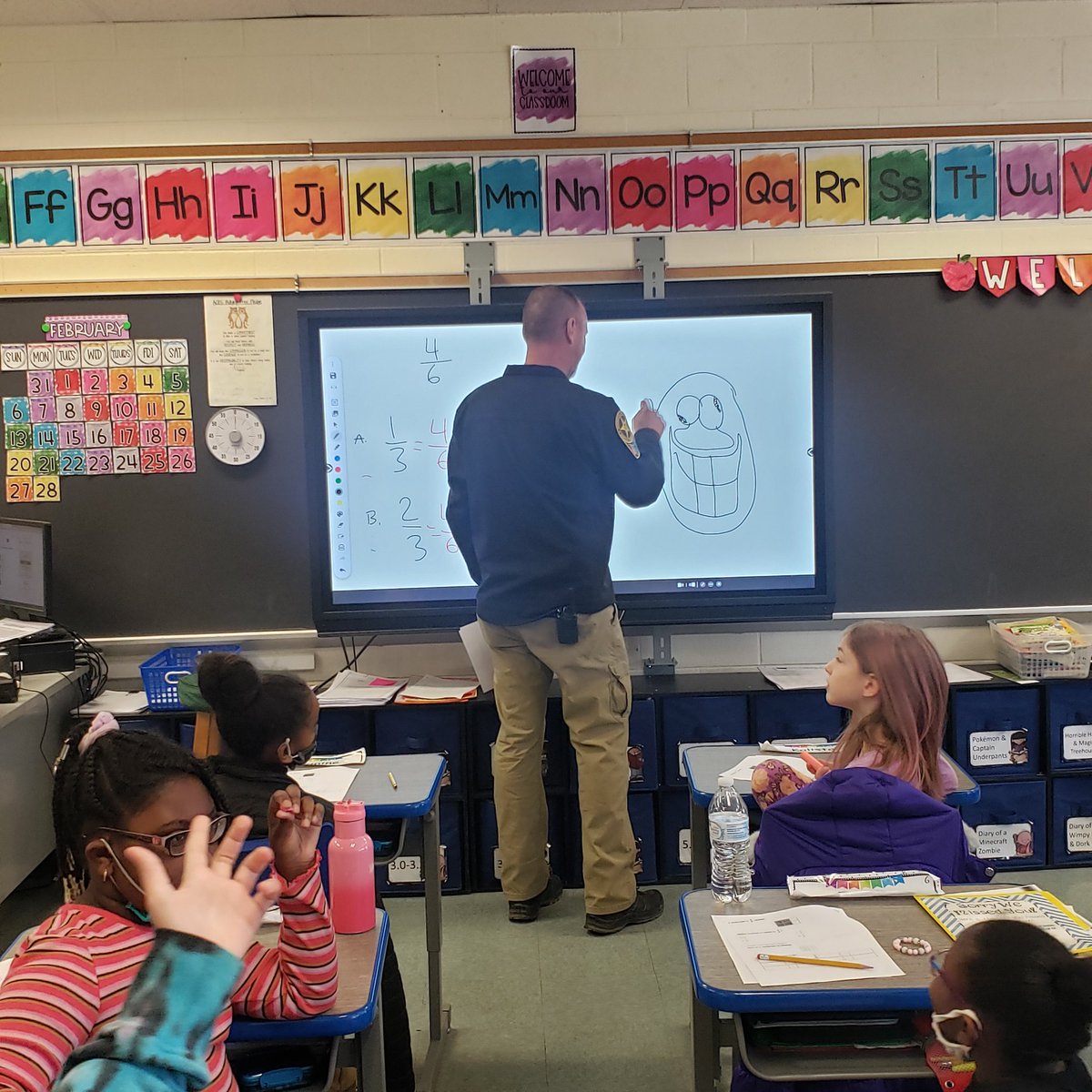 When your #Officer pretends to take over a math lesson.... that smiley face surely doesn't match my fractions 🤣🤪 <a href="/AmeliaElem/">Amelia Elementary</a> #ShineYourLight #relationships