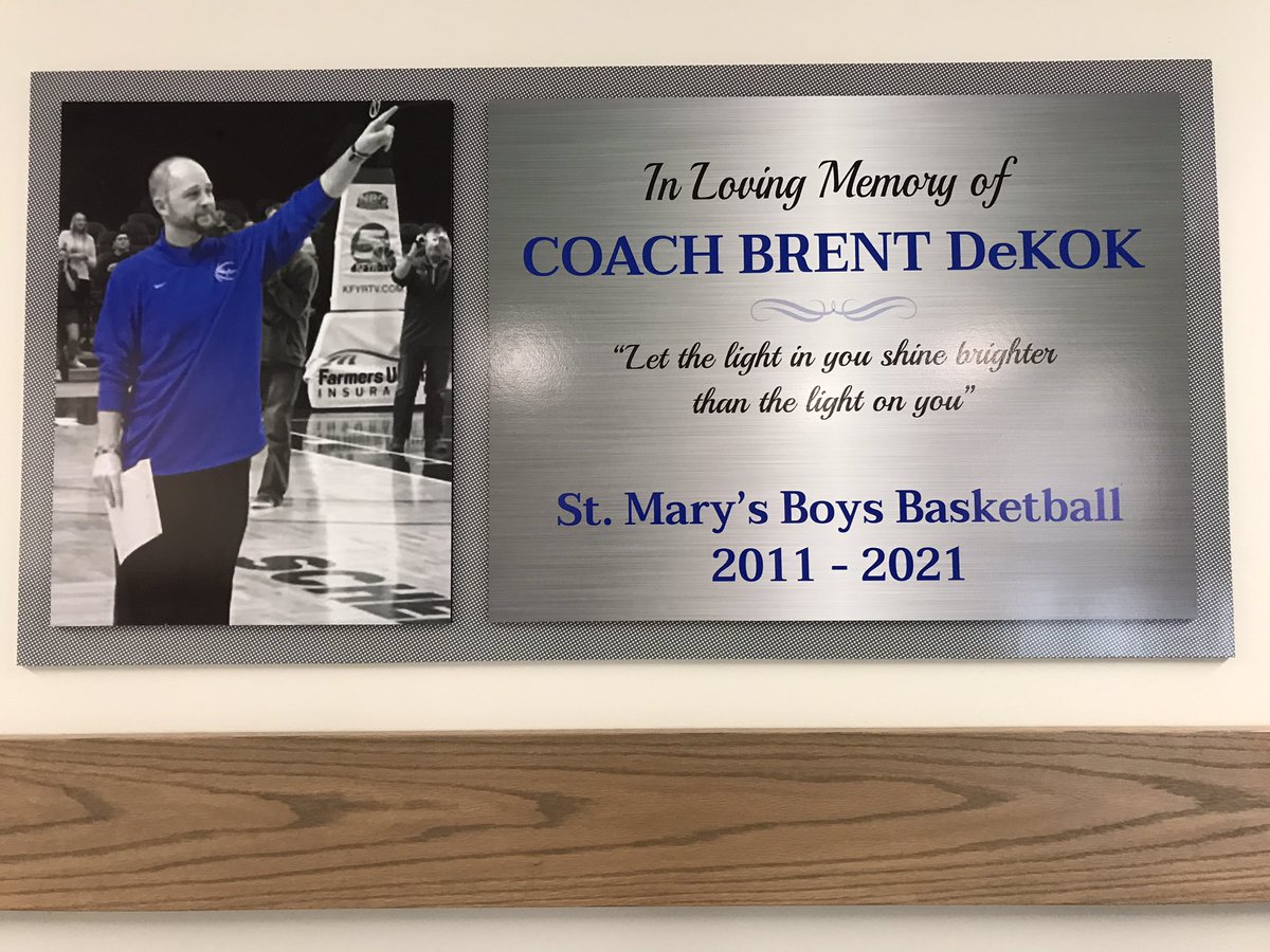 SMCHSbball's tweet photo. After you grab some food or snacks at the concession stand tonight, make sure you stop &amp; check out our new memorial for our former leader…who continues to lead us in many ways still! We love and miss you Coach DeKok! #SaintLife 🙏🏻😇 https://t.co/NgoySsve2p