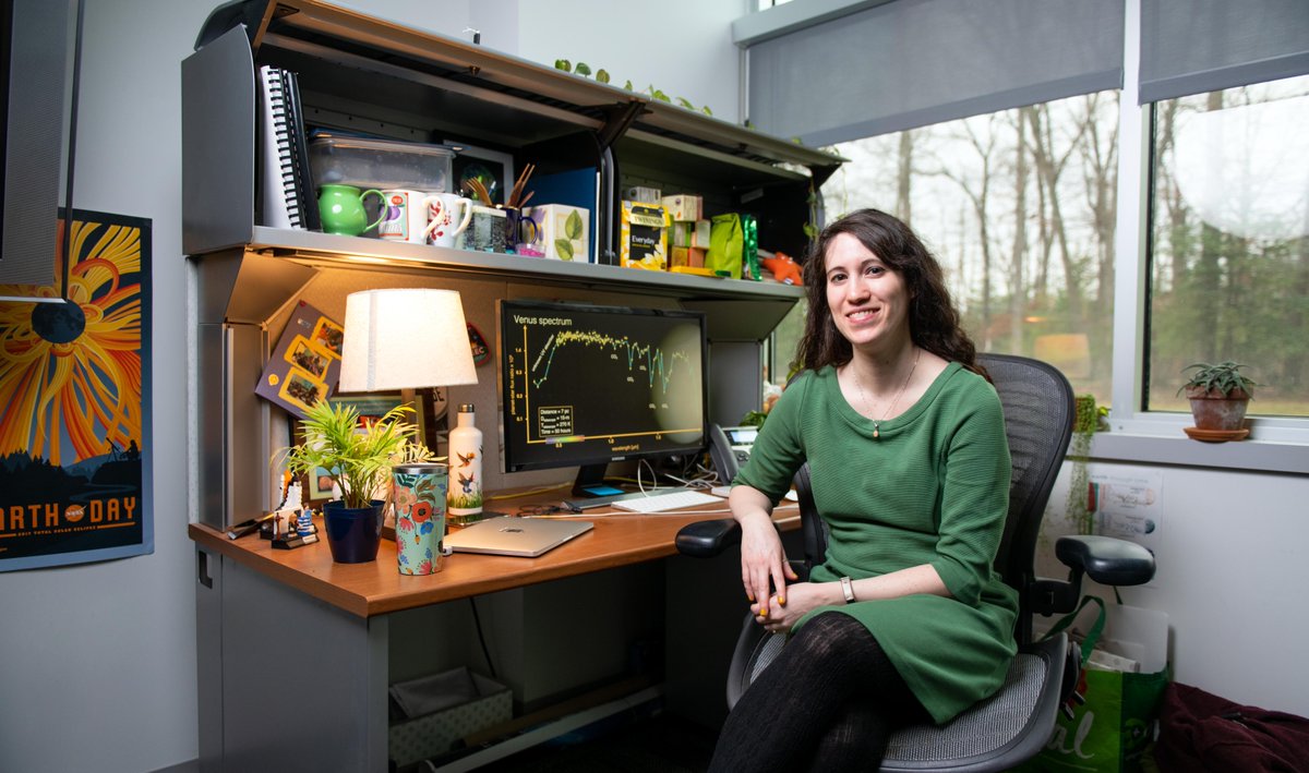 Giada Arney sitting at her desk wearing a green shirt, smiling 