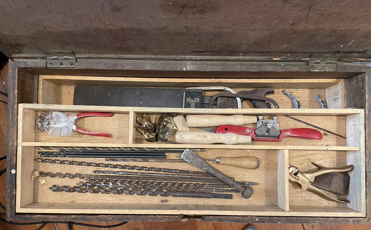 willtraves1's tweet photo. A 100 year old chest of tools and hardware that has found a new home in my little apartment. I’m particularly pleased with adzes, caulking irons, and marlinspike. The previous owner, a retired shipwright, was happy they were going to a good home. https://t.co/uMNPG3tKEw
