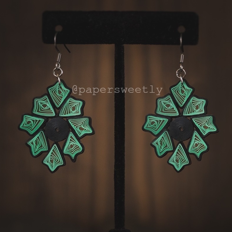 I call these paper quilled earrings 'Vanya' which means 'Forest". The green color represents the forever greenery of the forest and the black color represents the hidden darkness under the lush green and tall trees.⁠
.