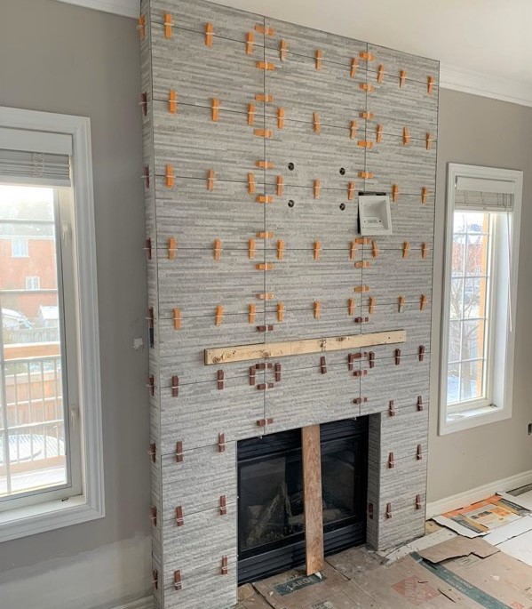 Preparing this elegant fireplace at our #LiverpoolProject! This fireplace feature is decked out in Grigio Matte tile from @CenturaTile 🙌