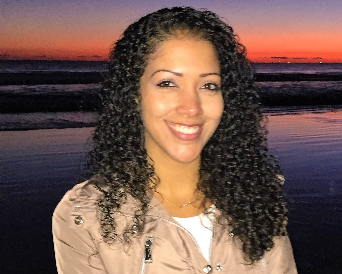 Portrait of a woman on the beach at sunset.