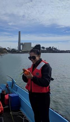 A woman conducts research on the small boat.