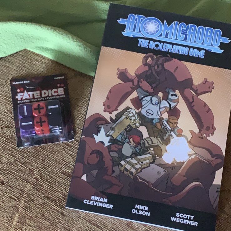 Ghastwood_niall's tweet photo. I then find it’s out of print. This made me sad😢 But I see a reply from @devlin1, Mike’s the central name on the cover of #AtomicRoboRPG. He has a spare copy. Anywho fast forward 2 weeks, a box from America is at my door. TTRPG folk are awesome, thanks again Mike ✌🏻💜 https://t.co/EpFCylIxbc