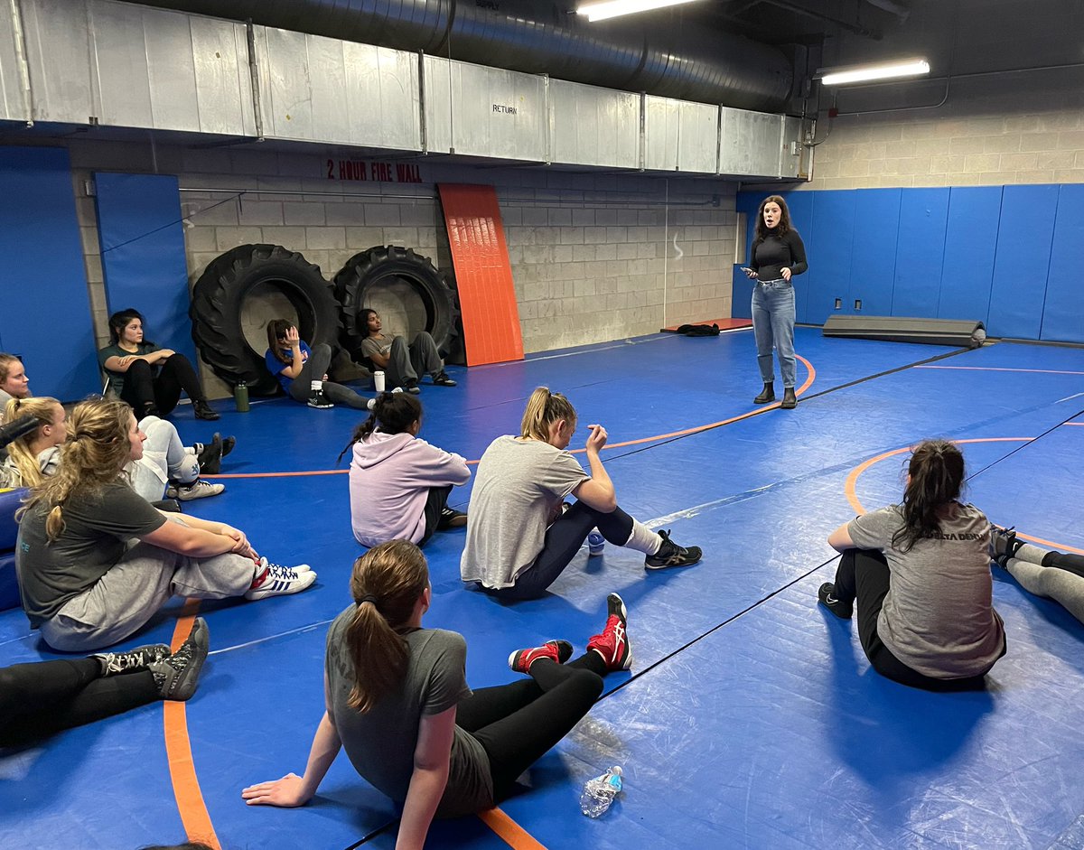 Class of 2020 grad and former team captain Alyssa Wallace talks to the team ahead of Sunday’s district tournament.