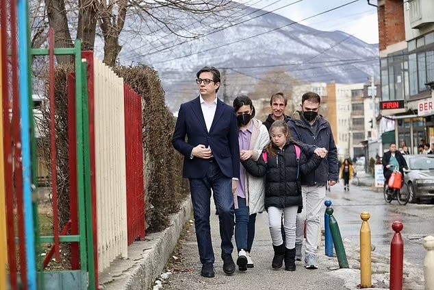 DailyMail's tweet photo. Upon hearing of Embla's treatment, President Pendarovski made a point by walking her to school

+ 'I came here to give my support and to raise awareness that inclusion is a basic principle,' Pendarovski said 

+ 'We are all equal in this society,' he added https://t.co/TgQpI9vL0y