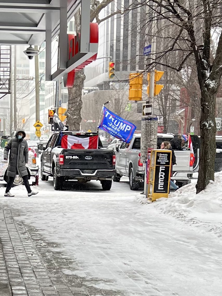 MarkGerretsen's tweet photo. More from Ottawa.

An upside Canada flag next to a Trump flag.

But please, tell me more about how this movement is about truckers. 🙄

#cdnpoli https://t.co/Wiub6iQGgg