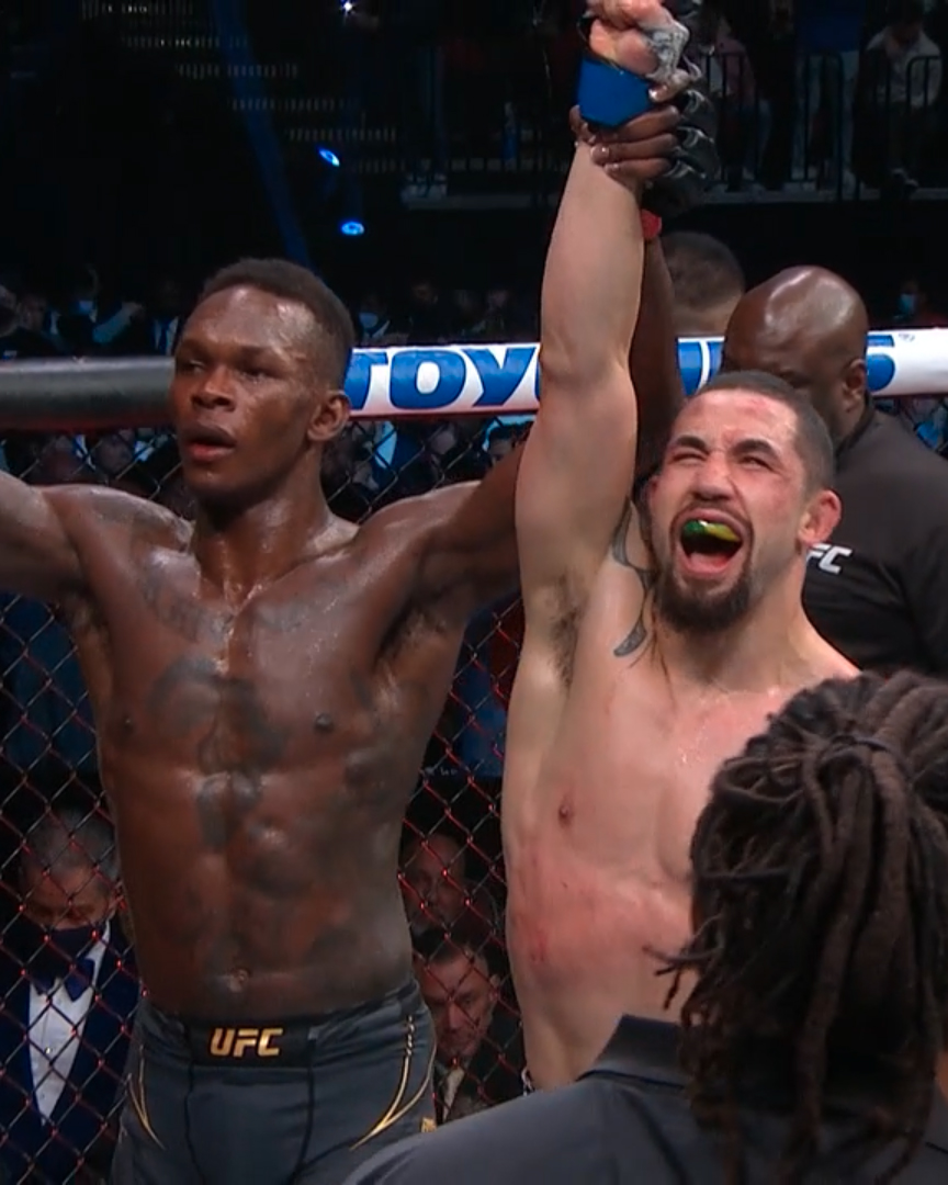 MMAFighting's tweet photo. Adesanya and Whittaker embraced after their rematch at #UFC271 https://t.co/Bs93bqJNqK