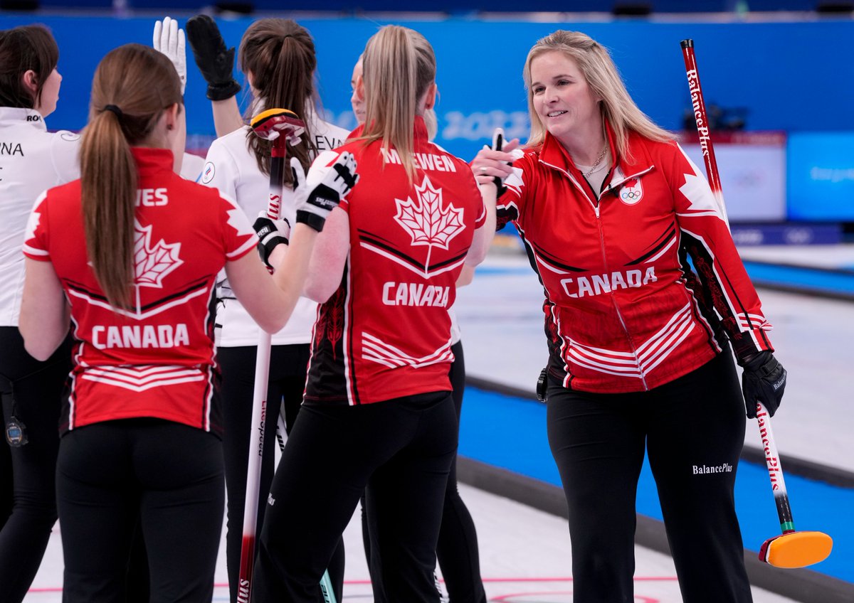 Members of the Team Canada women's curling team celebrate after downin...