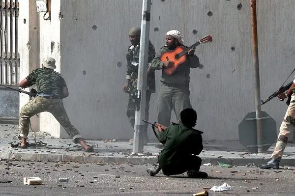 A man offers motivational music during a battle in Sirte, Libya, against forces loyal to Muammar Gaddafi in 2011.
