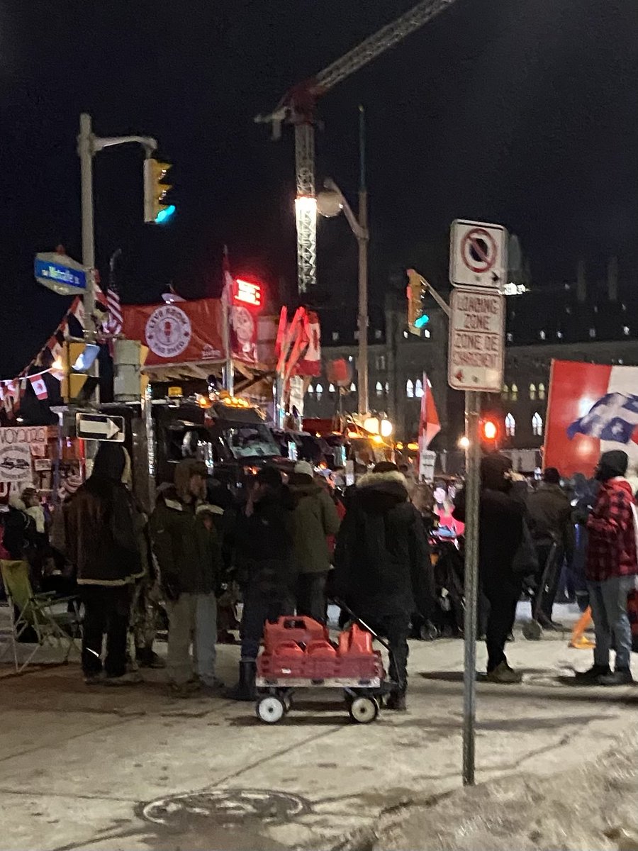 Gas Jerry cans rolling into Protest Village tonight as I watched. Police watched the guy pull it by so clearly the Emergencies Act so far hasn’t changed the attitudes of either side. #cdnpoli