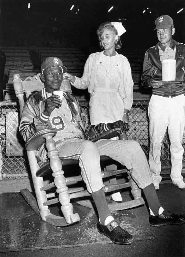 Tom Brady played until he was 44. Satchel Paige almost played at 60. September 25, 1965. At age 59, Satchel Paige relaxes in a rocking chair in the bullpen, preparing for the final game of his career by having a nurse rub liniment on his pitching arm. #GreatnessInOurDNA