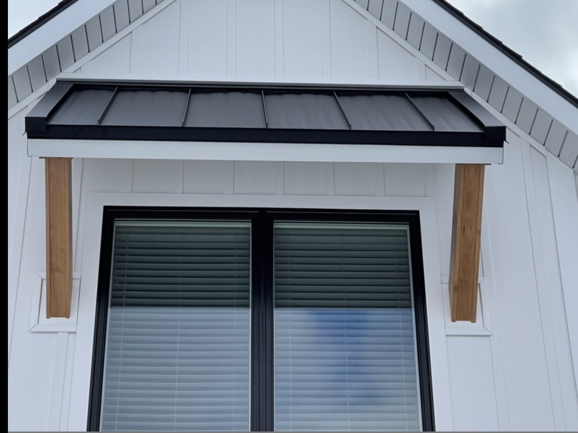 Everlast Composite siding &amp; Andersen windows with standing seam metal roof affect on this beautiful Kalamazoo, MI home project. #kalamazoomi #construction #sidingcontractor #doeverythingwithCharacter