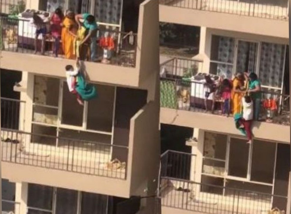 dekho_pk's tweet photo. Indian woman risks son's life by hanging him from 10th-floor balcony to fetch her sari https://t.co/TDPfUIUPyc